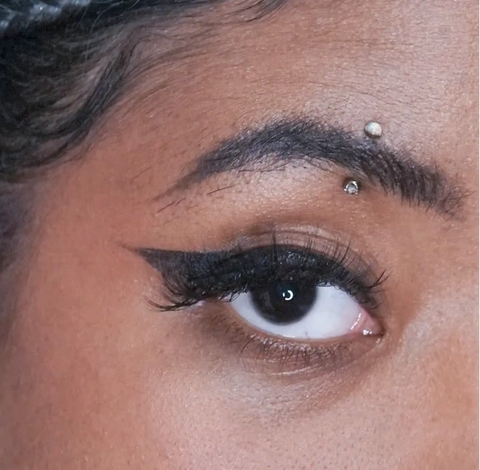 Vertical eyebrow piercing